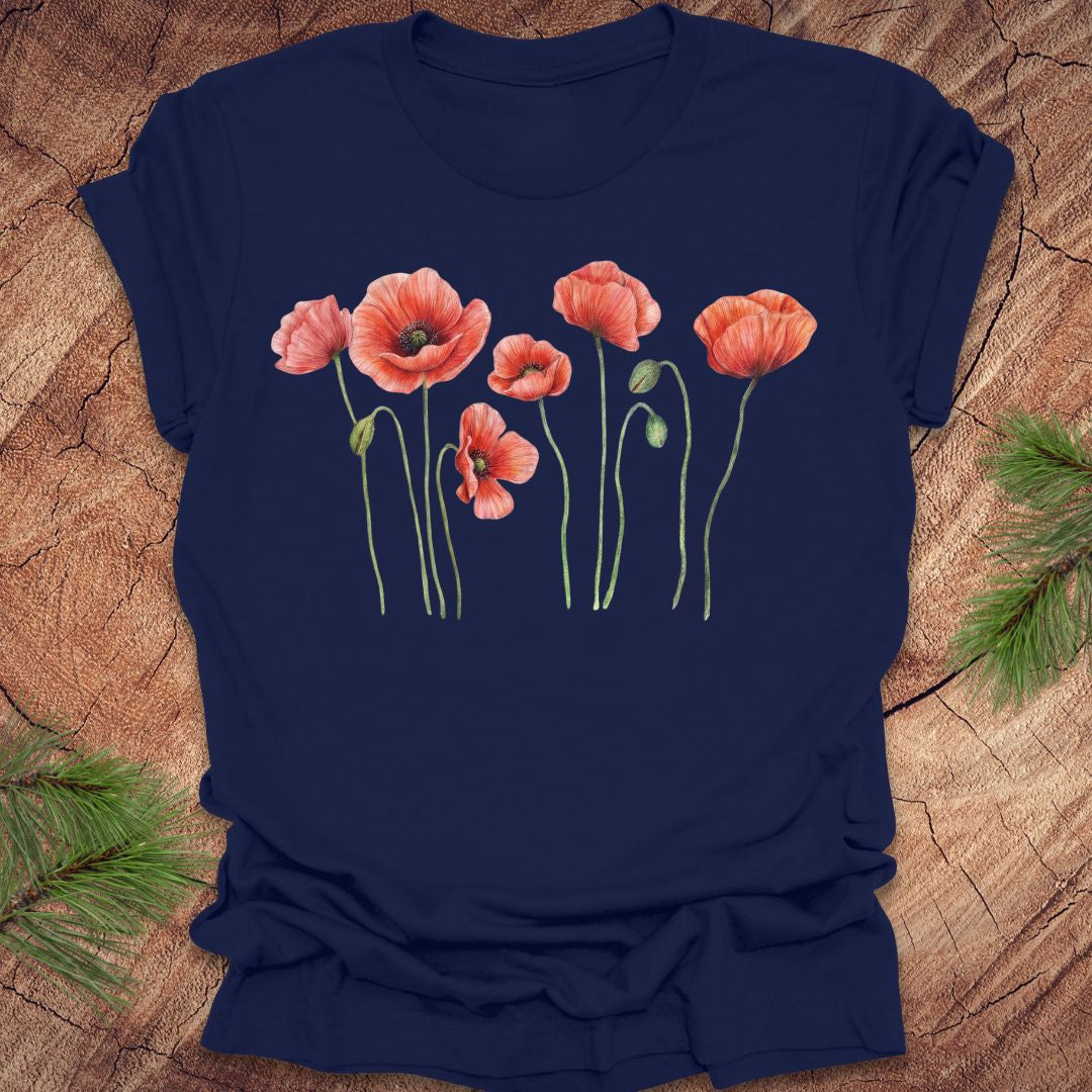 Navy blue t-shirt with red poppy flower design on a wooden surface