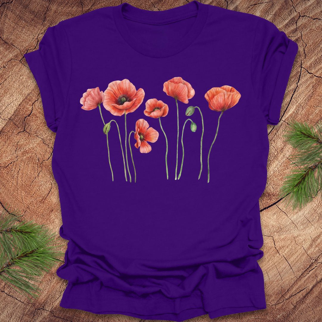 Purple t-shirt with red floral design on a wooden surface