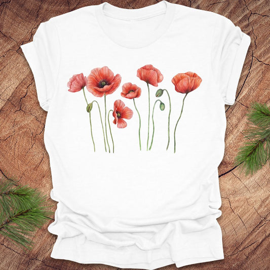 White t-shirt with red floral design on a wooden surface