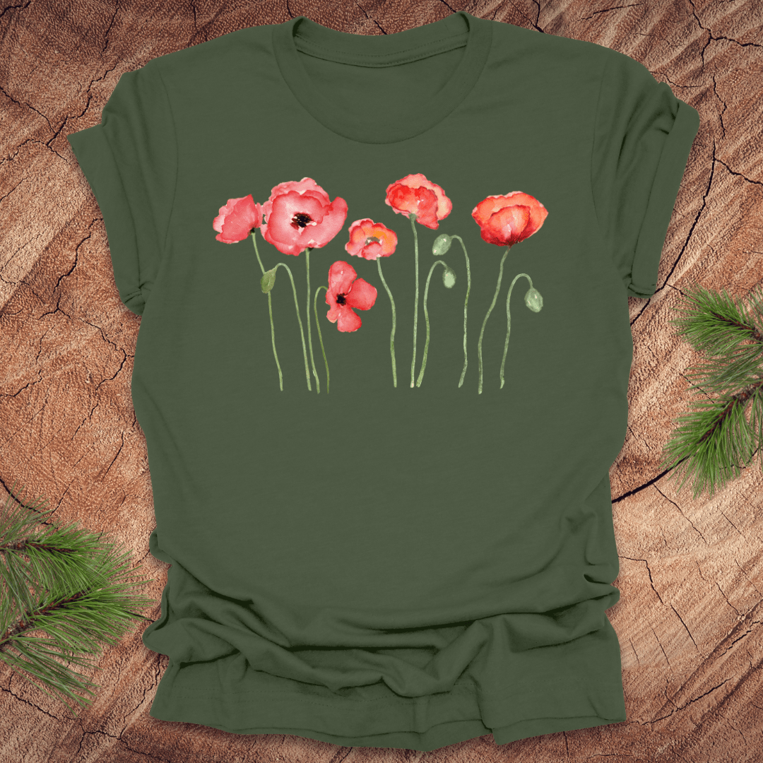 Green t-shirt with red poppy design on a wooden surface
