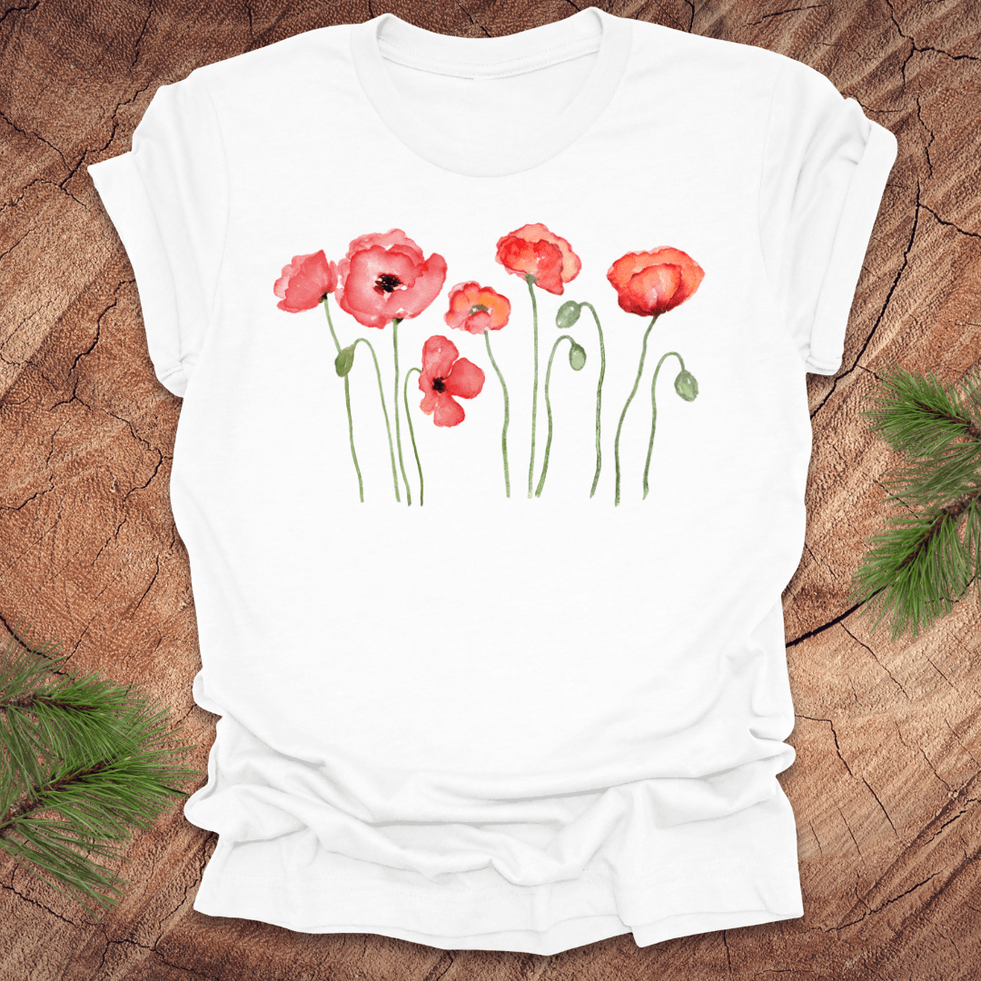 White t-shirt with red poppy design on a wooden surface