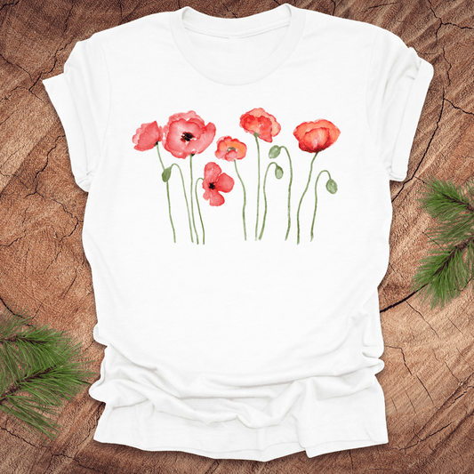 White t-shirt with red poppy design on a wooden surface
