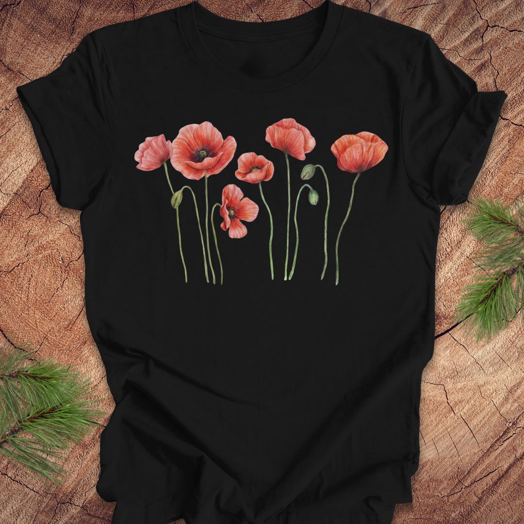 Black t-shirt with individual poppy flowers on a wood background.