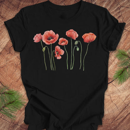 Black t-shirt with individual poppy flowers on a wood background.