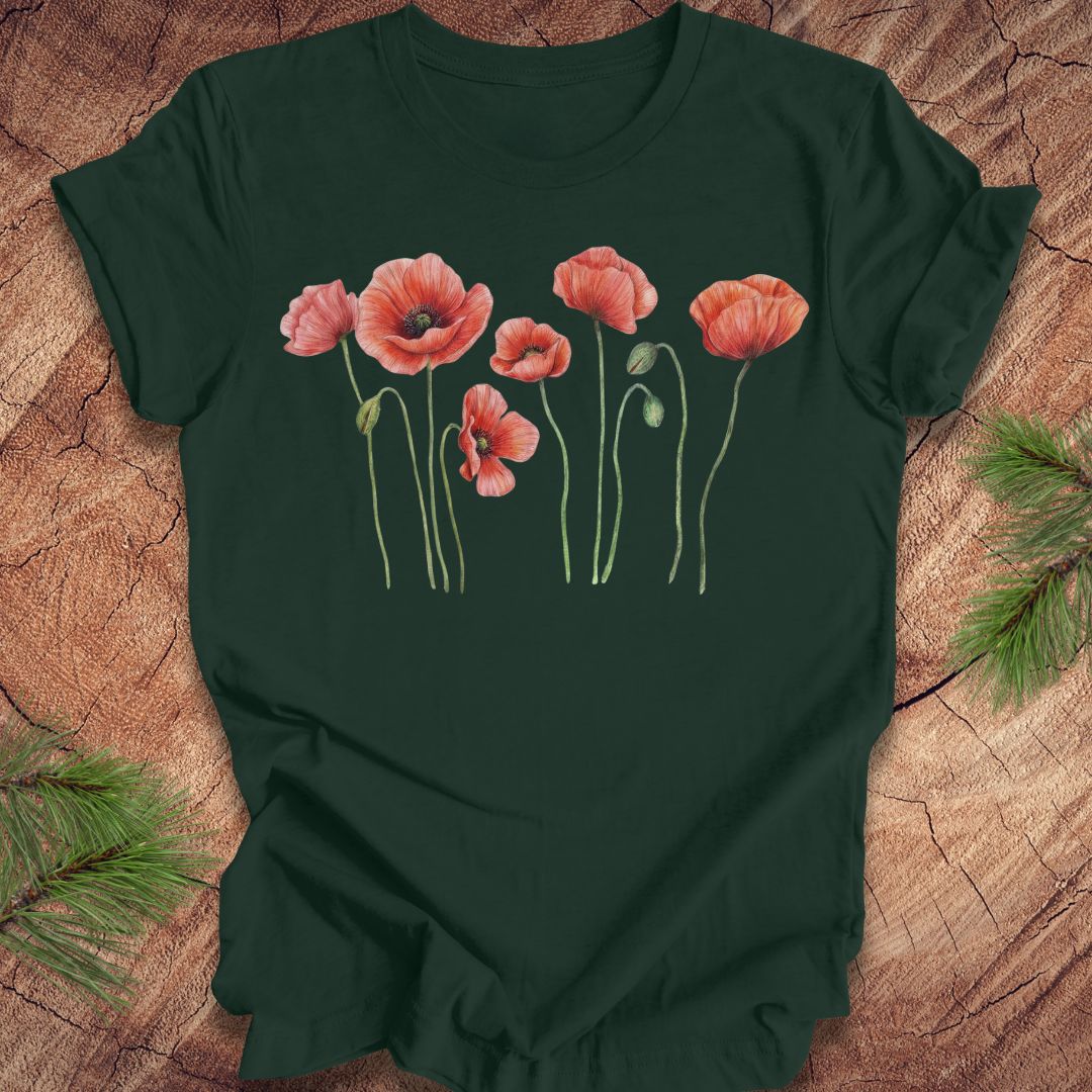 Dark green t-shirt with individual poppy flowers on a wood background.