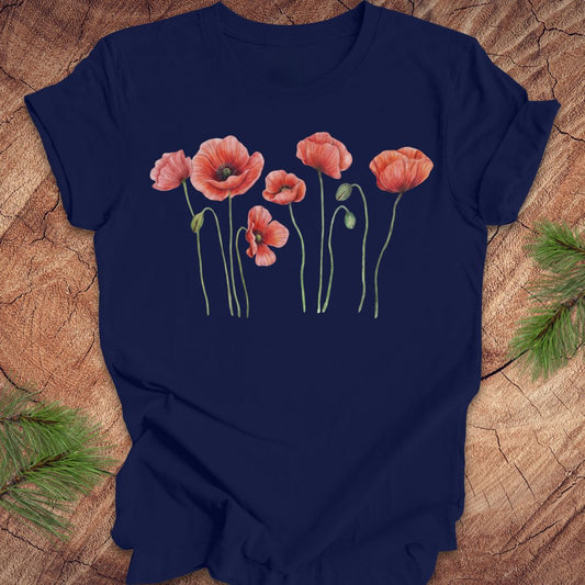 Navy blue t-shirt with individual poppy flowers on a wood background.