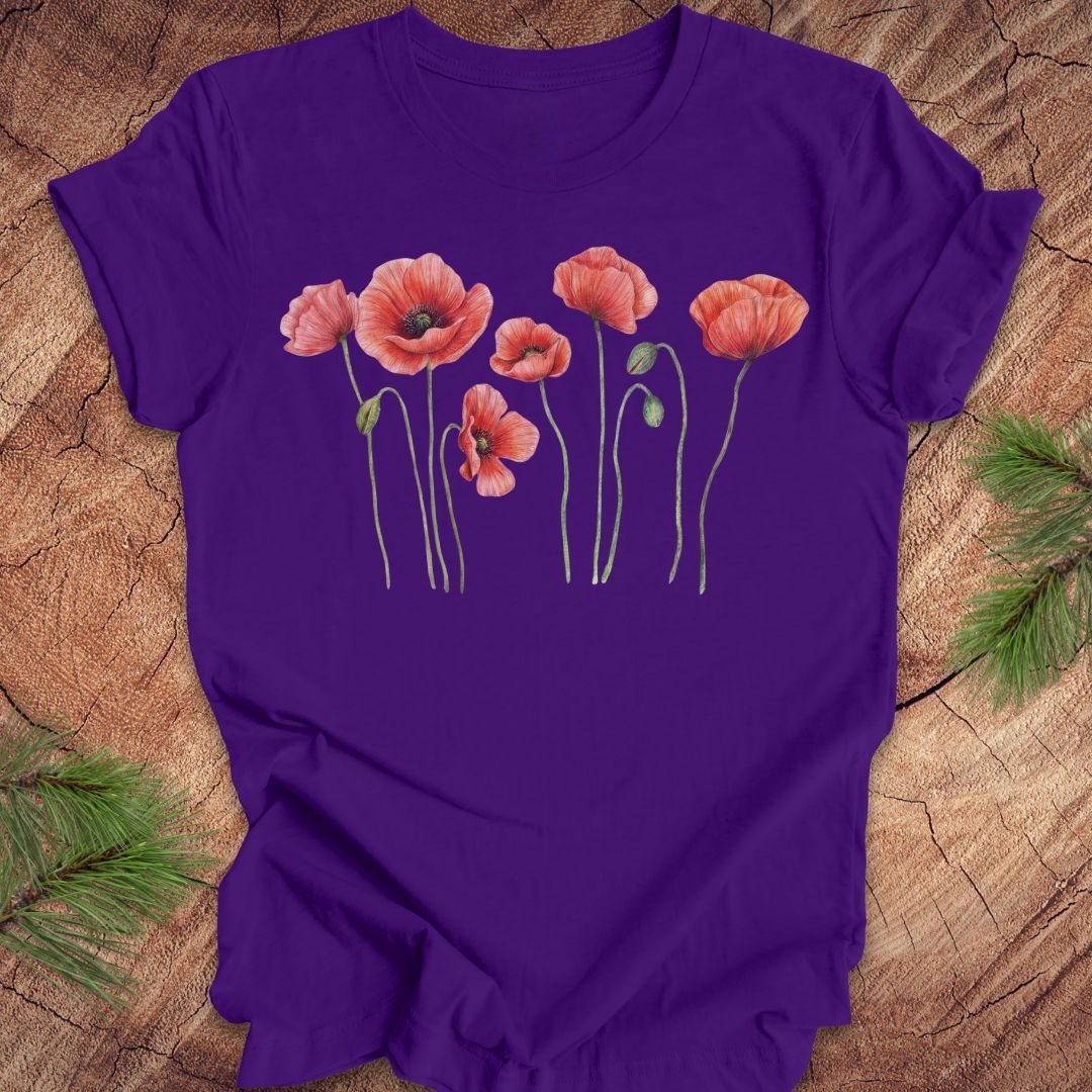 Pueple t-shirt with individual poppy flowers on a wood background.