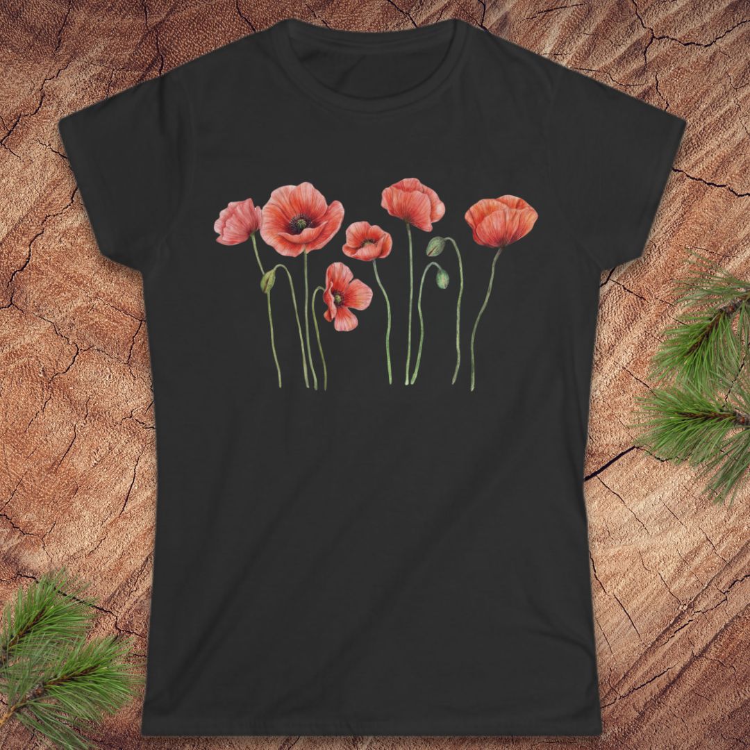Black t-shirt with red poppy flower design on a wooden surface