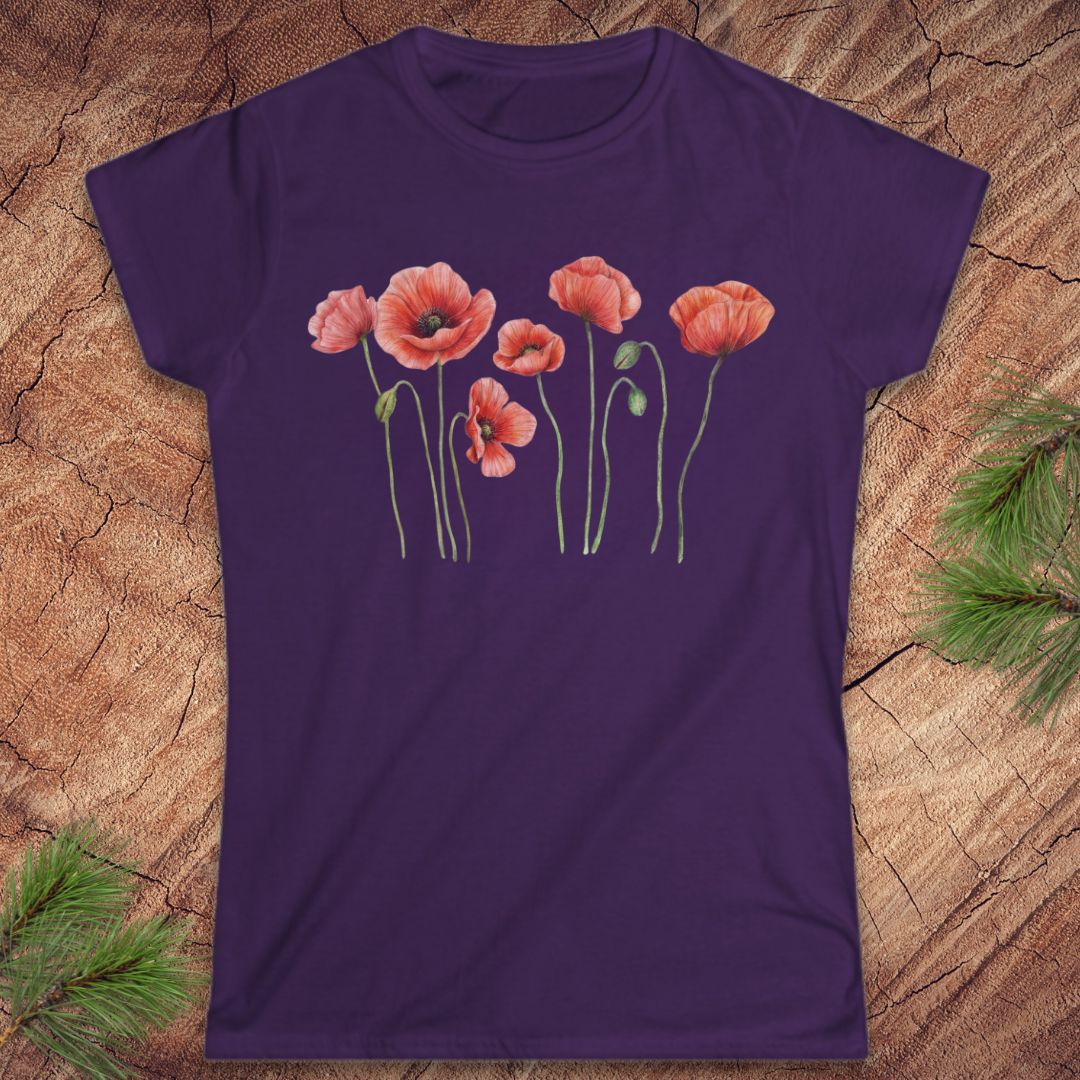 Purple t-shirt with red poppy flower design on a wooden surface