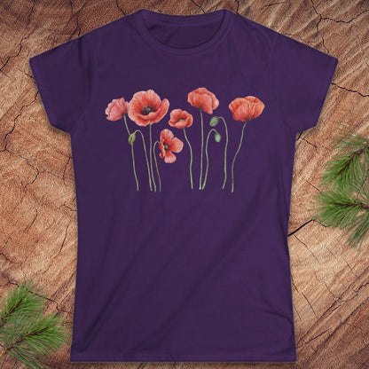 Purple t-shirt with red poppy flower design on a wooden surface