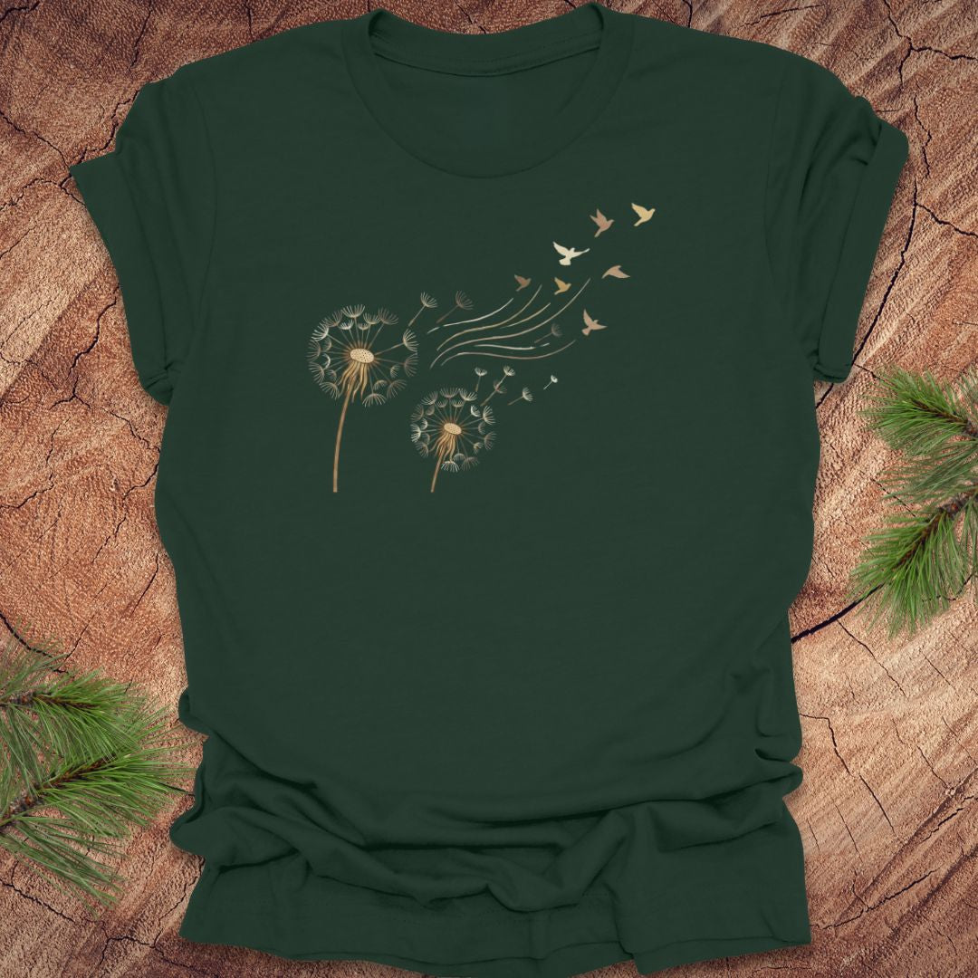 Dark green t-shirt with dandelion and bird graphic on a wooden surface