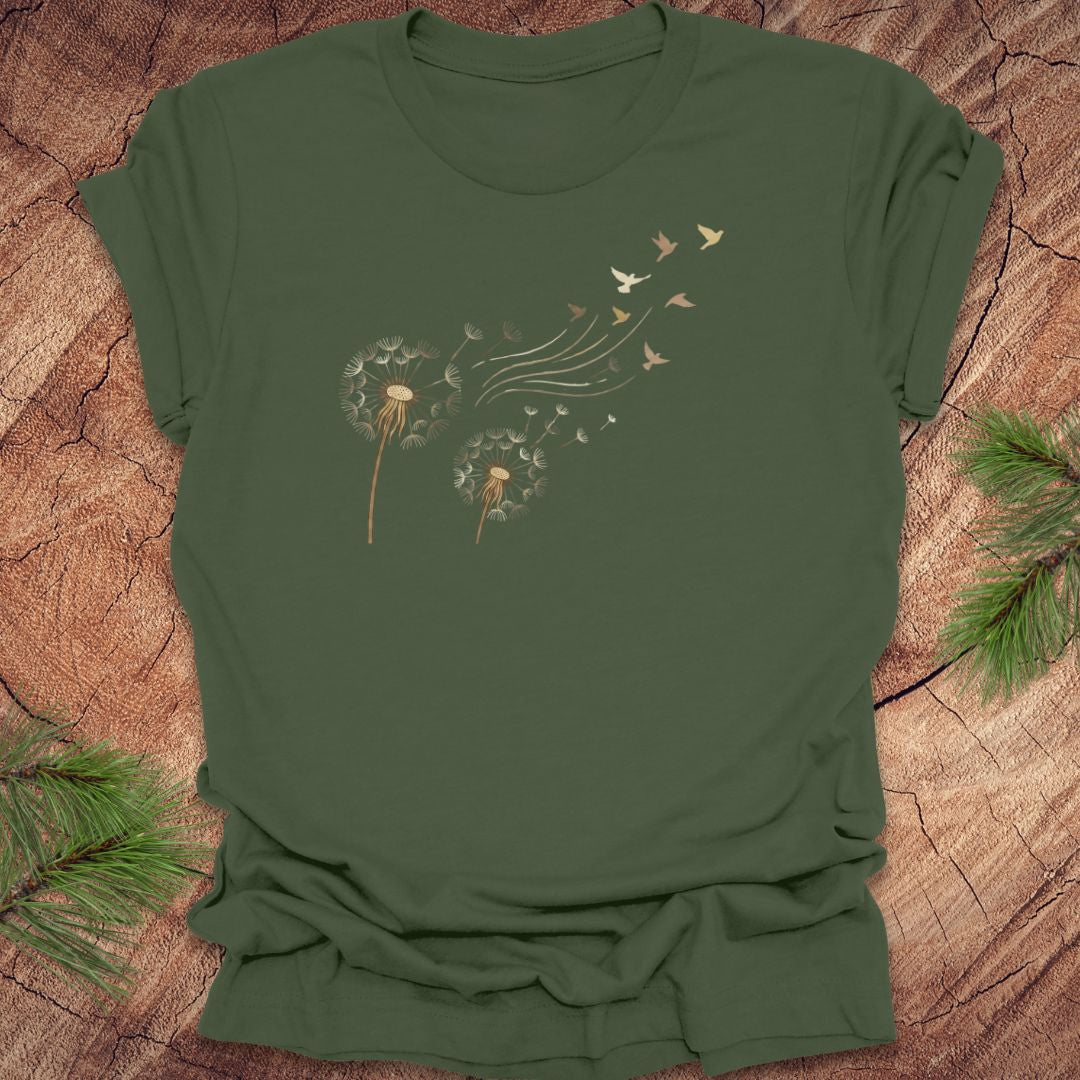 Green t-shirt with dandelion and bird graphic on a wooden surface