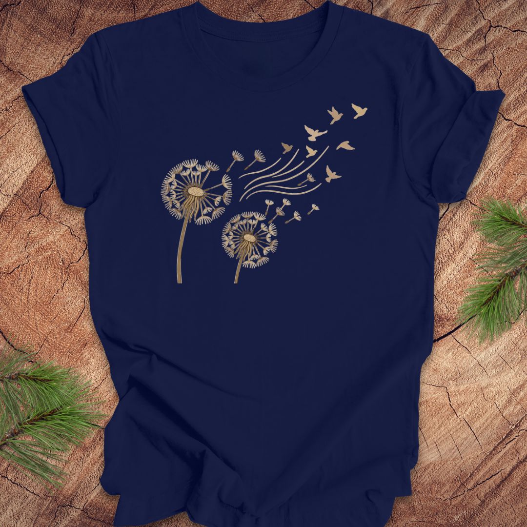 Navy blue t-shirt with dandelion and bird design on a wooden surface