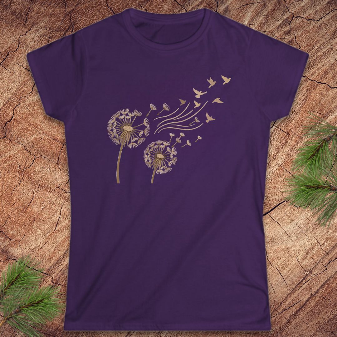 Purple t-shirt with a dandelion and birds on a wood background.