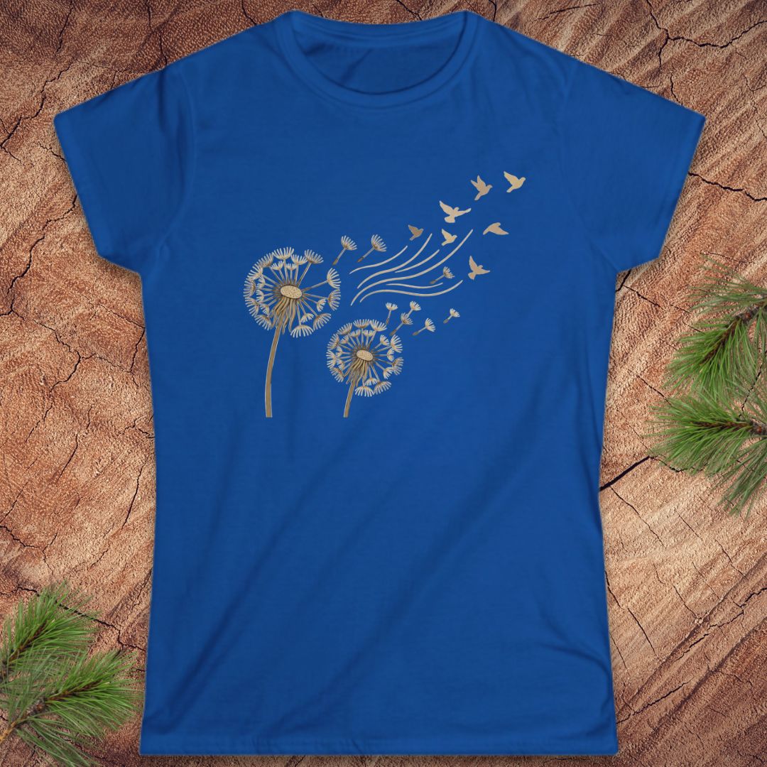 Blue t-shirt with a dandelion and birds on a wood background.