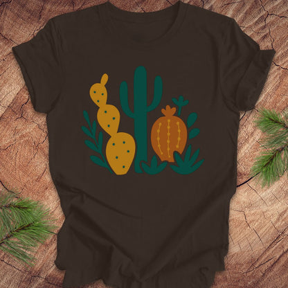 Brown t-shirt with cactus design on a wooden surface