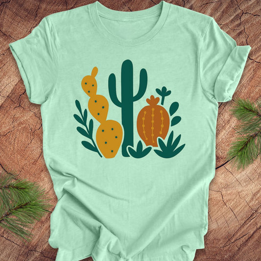 Light green t-shirt with cactus design on a wooden surface