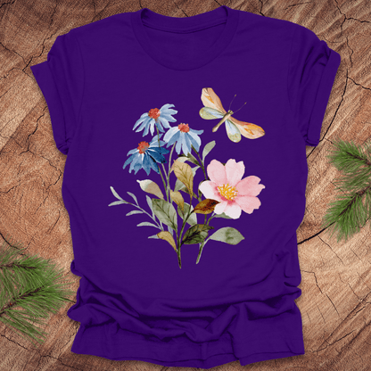 Purple t-shirt with floral design featuring flowers and a butterfly on a wooden surface.