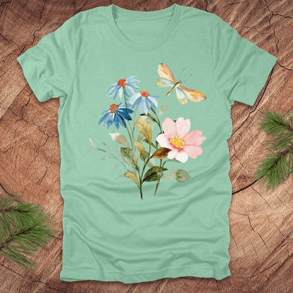 Mint green t-shirt with floral design and dragonfly on a wooden surface