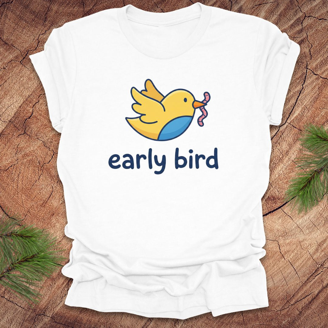 White t-shirt with a yellow bird graphic and 'early bird' text on a wooden surface.