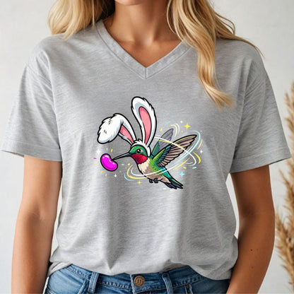 Person wearing a gray v-neck t-shirt with a colorful graphic design of a hummingbird with bunny ears.