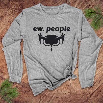 Gray long-sleeve shirt with 'ew. people' text and owl graphic on a wooden surface