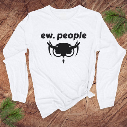 White long-sleeve shirt with 'ew. people' text and owl design on a wooden surface.