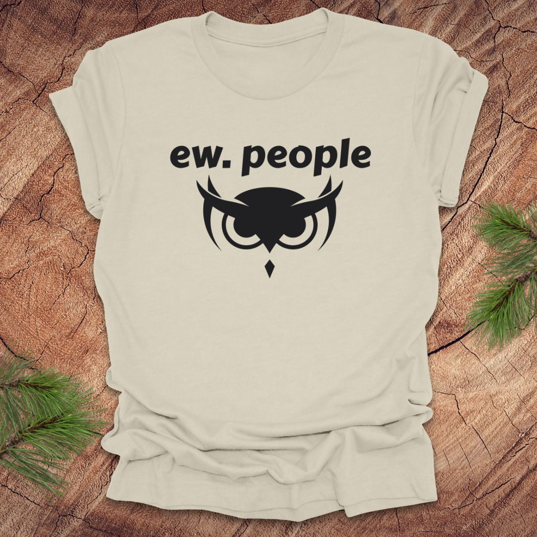 Beige t-shirt with 'ew. people' text and owl graphic on a wooden surface