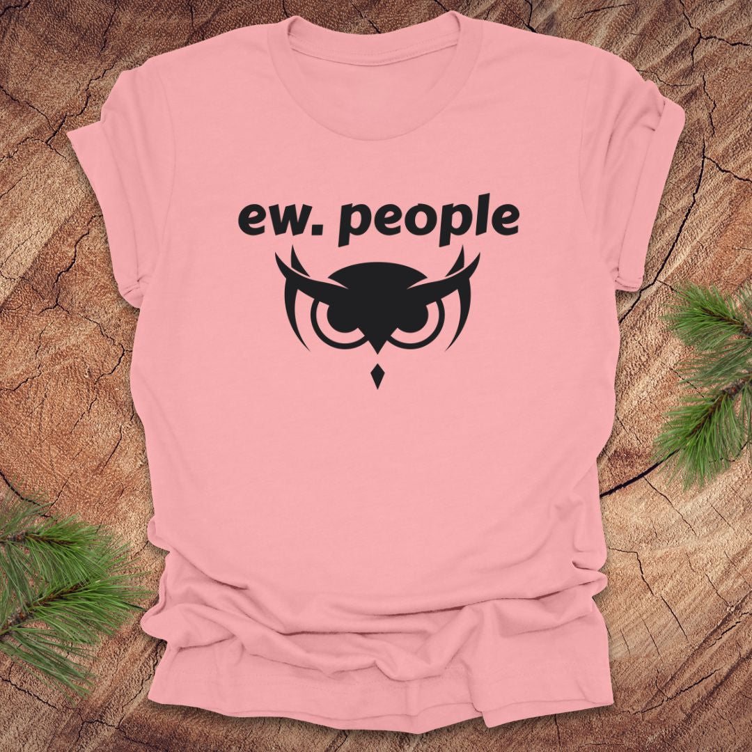 Pink t-shirt with 'ew. people' text and owl graphic on a wooden surface