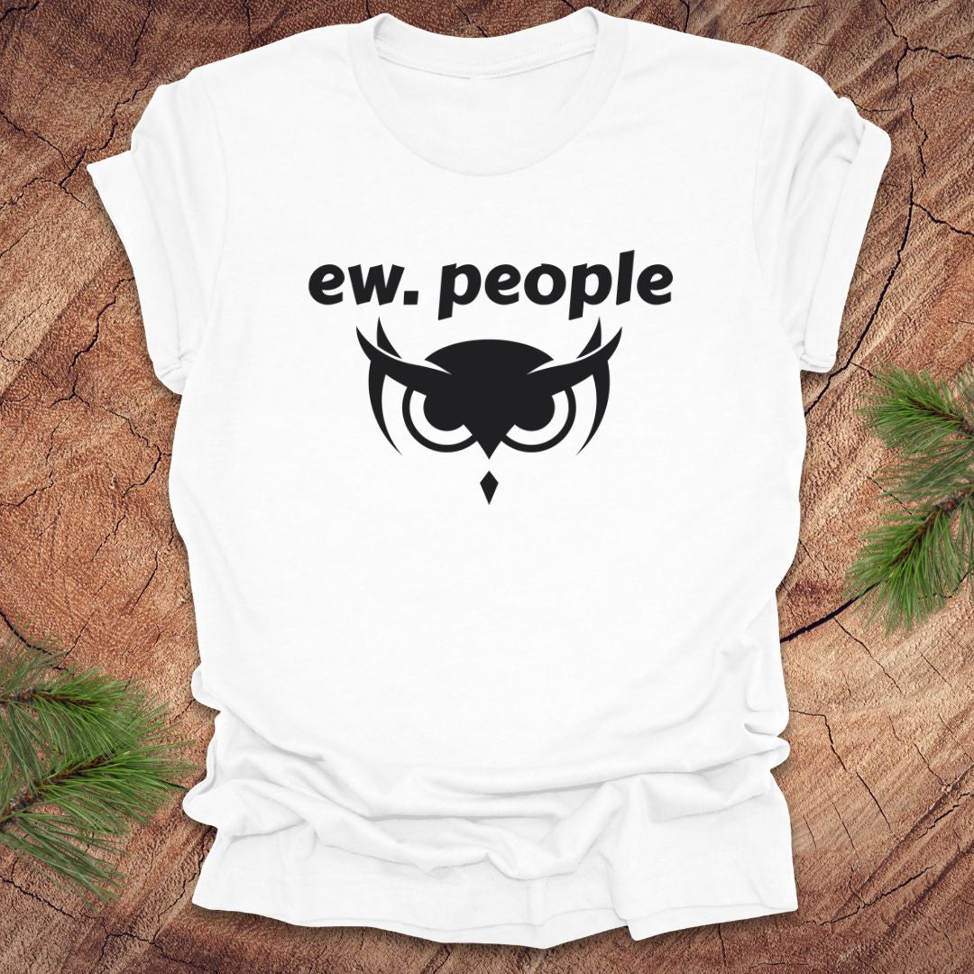 White t-shirt with 'ew. people' text and owl graphic on a wooden surface