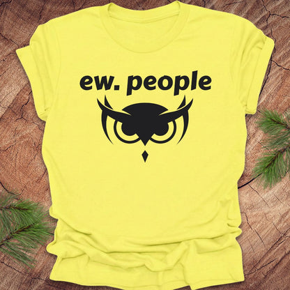 Yellow t-shirt with 'ew. people' text and graphic on a wooden surface