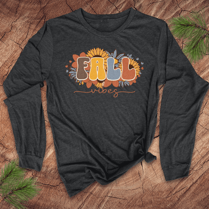 Dark gray long-sleeve shirt with 'Fall Vibes' text and sunflower design on a wooden surface.
