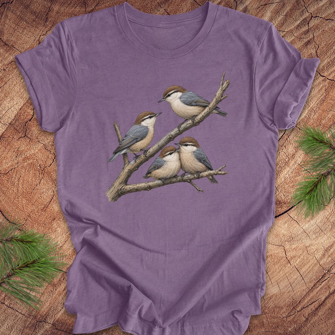 Purple t-shirt with nuthatch bird design on a wooden surface