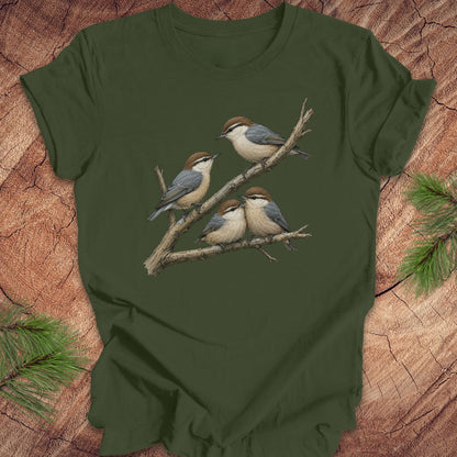 Green t-shirt with nuthatch bird design on a wooden surface