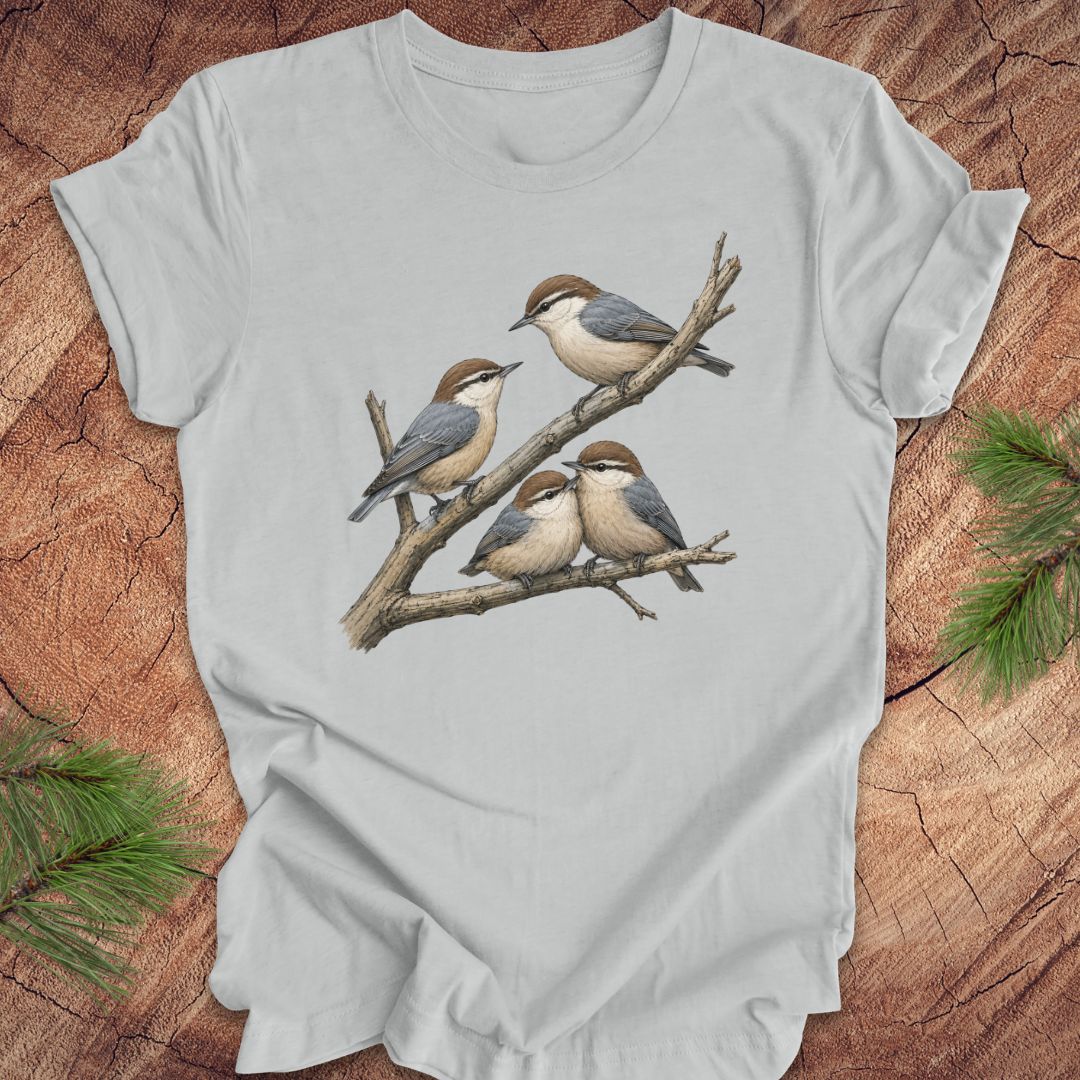 Gray t-shirt with nuthatch bird design on a wooden surface