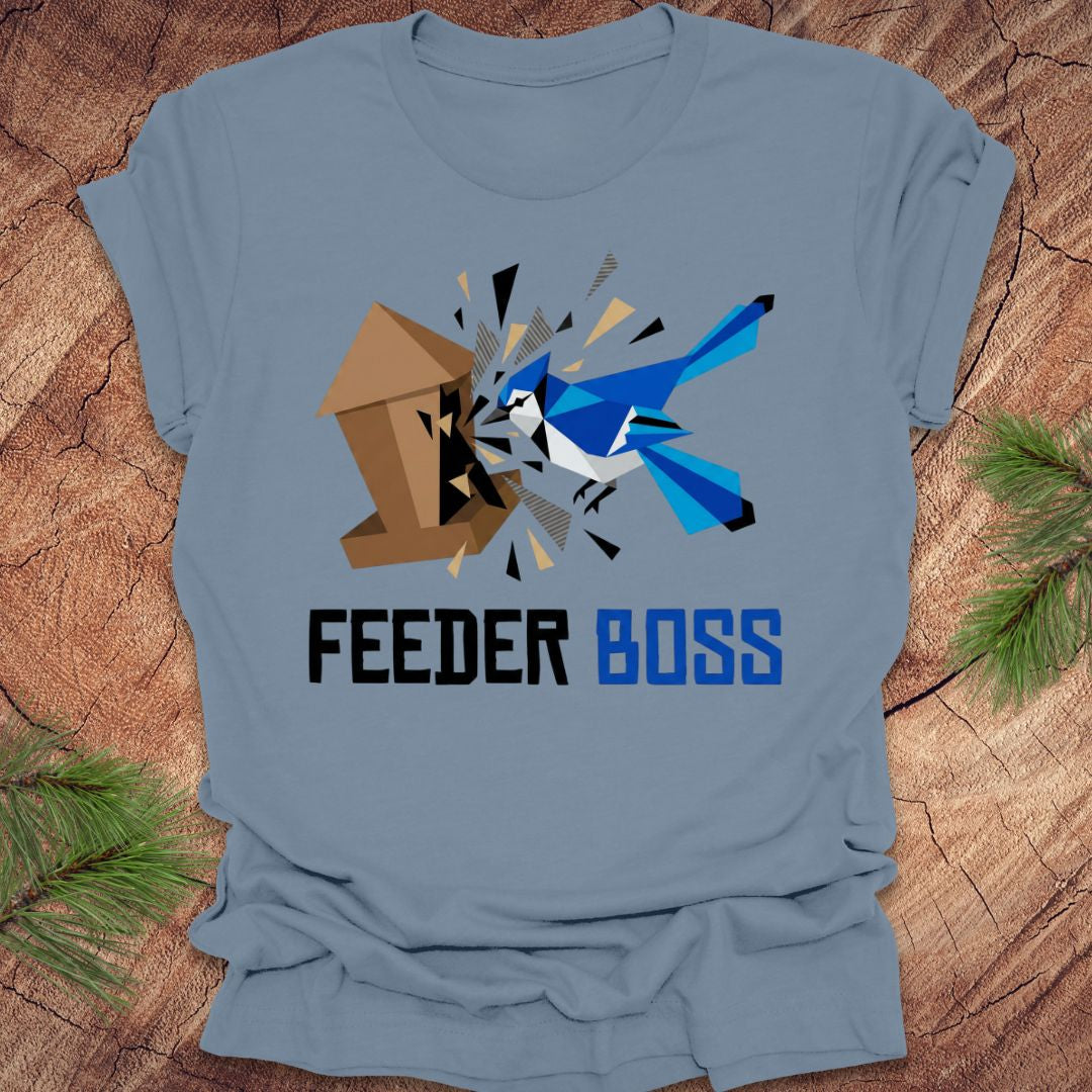 Steel blue t-shirt with a graphic design of a blue bird and birdhouse with text, 'feeder boss' on a wooden surface.