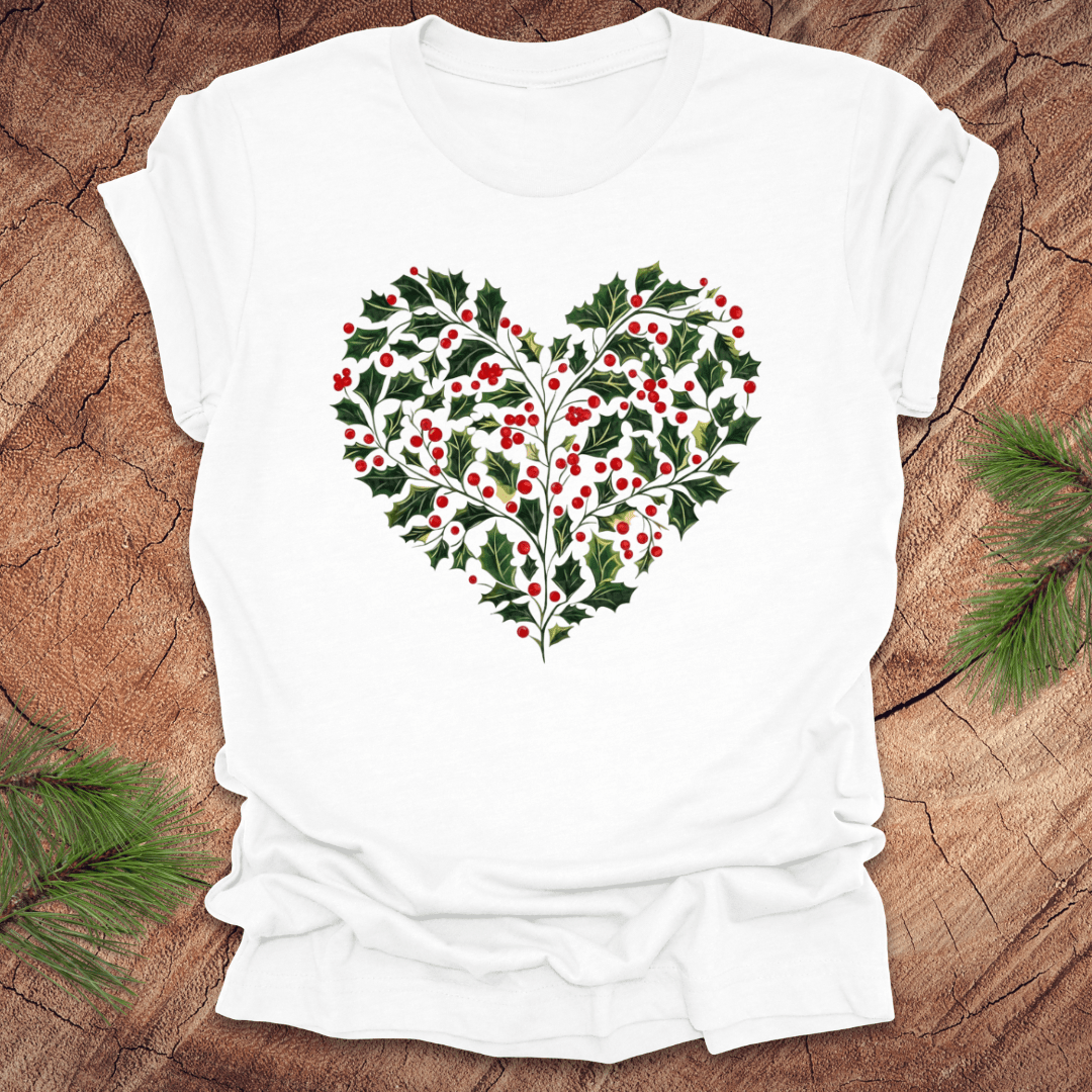 White t-shirt with a heart-shaped holly design on a wooden surface