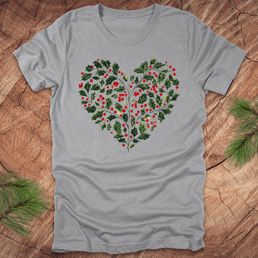 Gray t-shirt with a heart-shaped holly design on a wooden surface