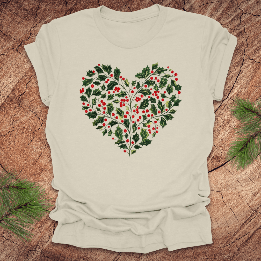 Beige t-shirt with a heart-shaped holly design on a wooden surface