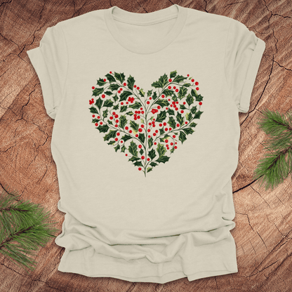 Beige t-shirt with a heart-shaped holly design on a wooden surface