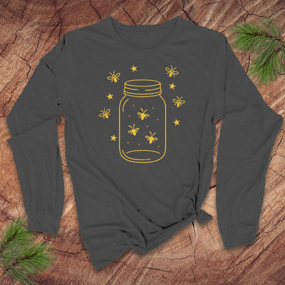Dark gray long-sleeve shirt with yellow mason jar and firefly design on a wooden surface.