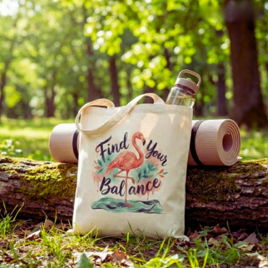 Tote bag with flamingo design and 'Find Your Balance' text in a forest setting.