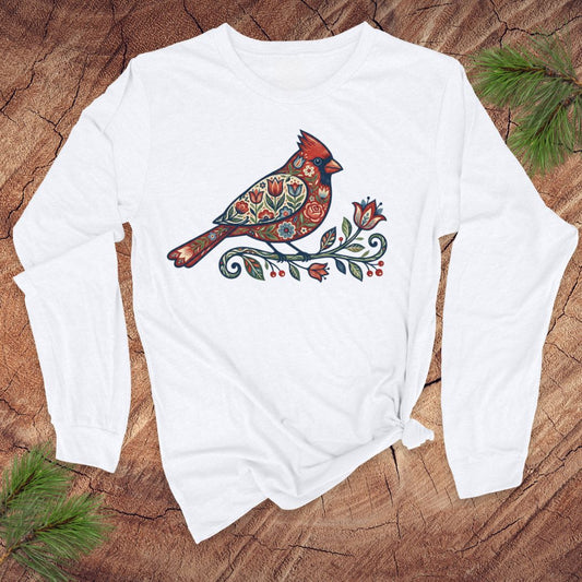 White long-sleeve shirt with a colorful cardinal design on a wooden surface.
