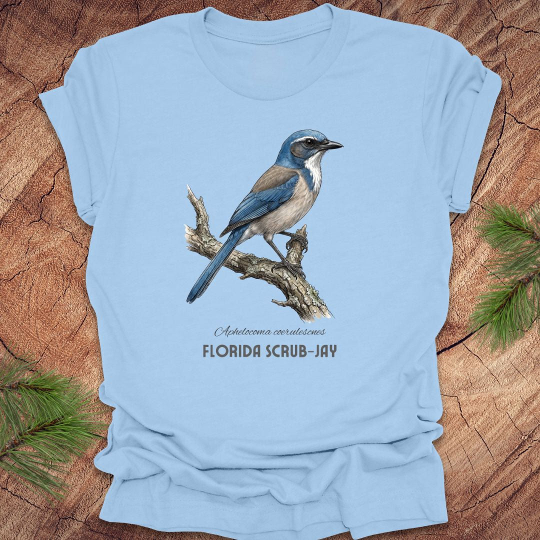 Light blue t-shirt with a Florida Scrub-Jay design on a wooden surface.