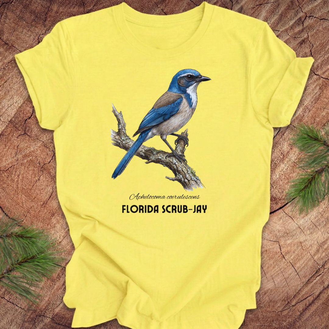 Yellow t-shirt with a Florida Scrub-Jay design on a wooden surface