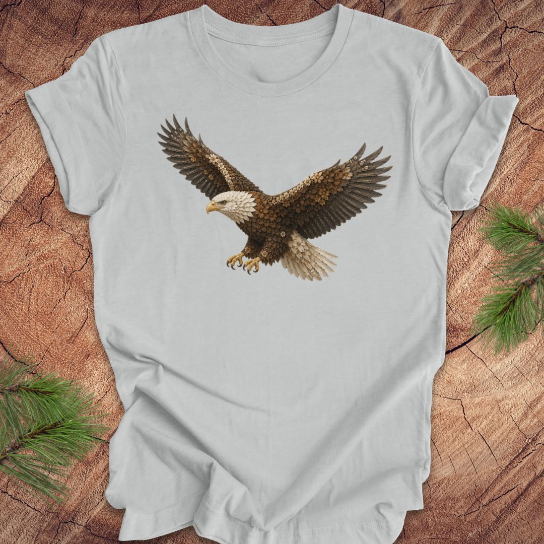 Gray t-shirt with an eagle made of flowers on a wood background.