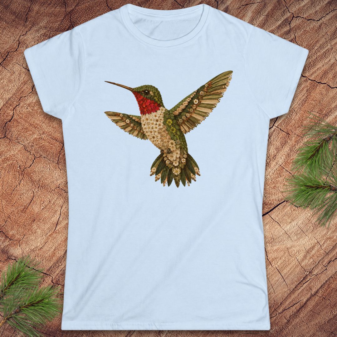 Blue t-shirt with a hummingbird made of flowers on a wood background. 