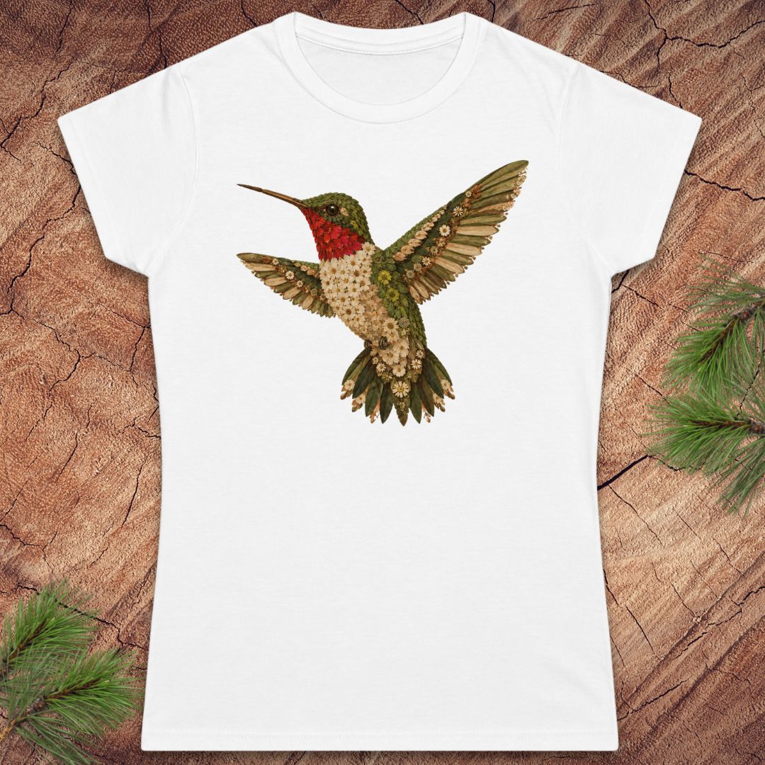 White t-shirt with a hummingbird made of flowers on a wood background.
