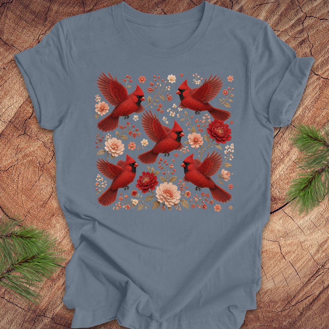 Blue t-shirt with cardinals and flowers on a wood background.