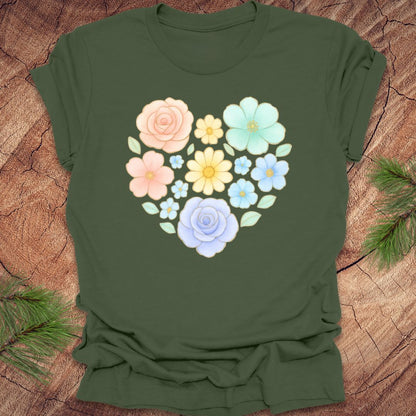 Green t-shirt with a floral heart design on a wooden surface